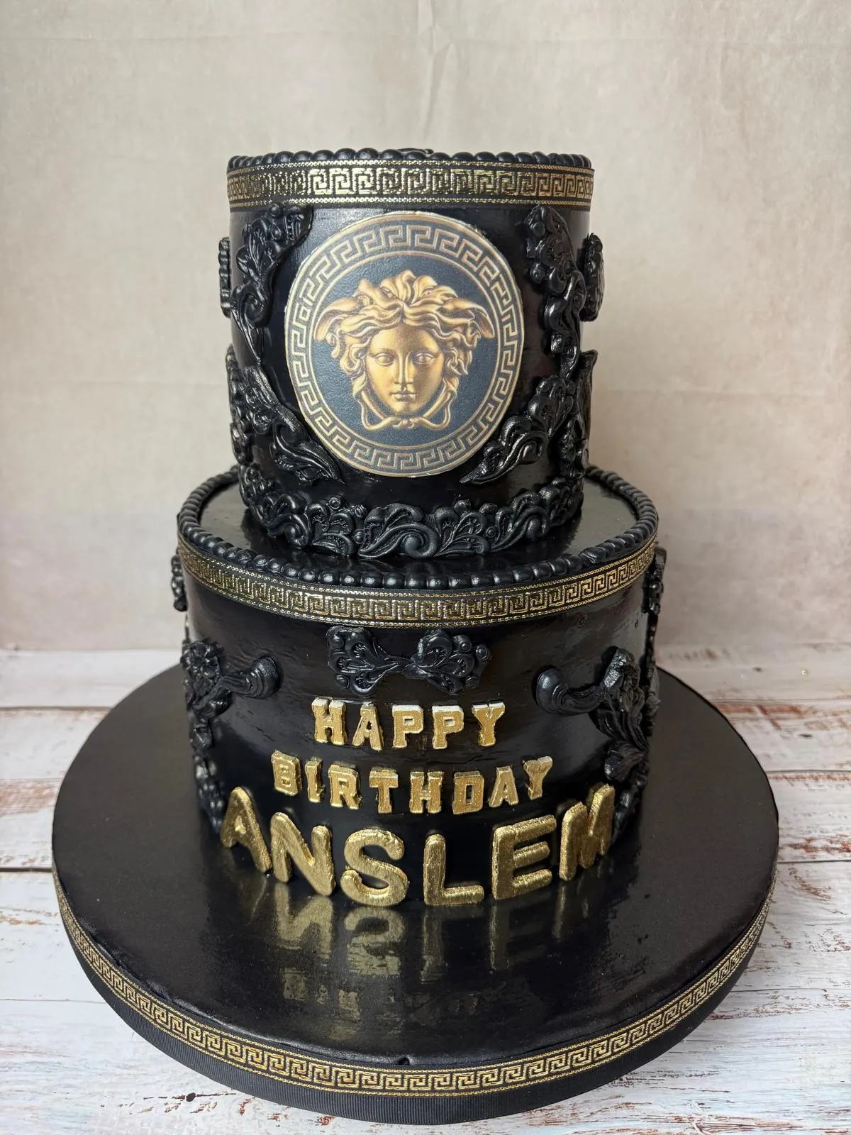 Black and gold two-tier 65th birthday cake